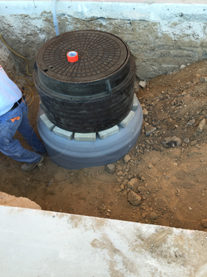 close-up view of standard grade rings - frame - cover installed on a Packaged Metering Manhole