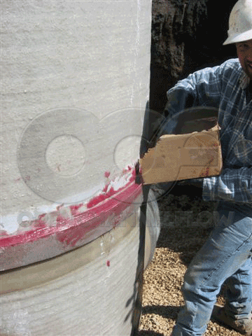 adhesive mixture poured into channel on base section of Metering Manhole