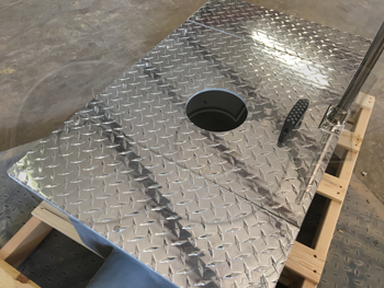 Aluminum diamond plate cover with ultrasonic sensor cut-out mounted on a fiberglass weir box