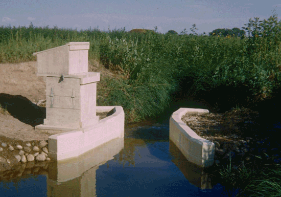 concrete Parshall flume measuring water in an irrigation channel