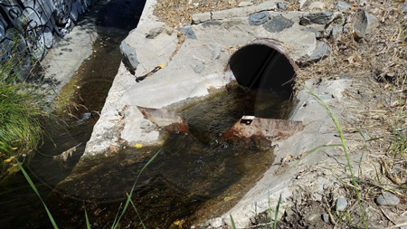 corroded steel v-notch weir plate measuring storm pipe drainage