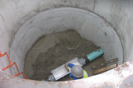 A wood block is installed in the throat of a Palmer-Bowlus flume to crib (shore up) the throat during the installation process