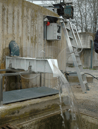 vertical pipe discharging into above grade mounted fiberglass H Flume