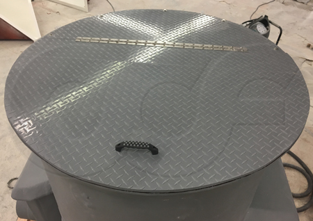 flat fiberglass manhole top mounted on a 48-inch diameter packaged metering manhole integrating a Parshall flume