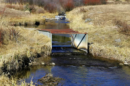 irrigation flow through a galvanized steel Parshall flume