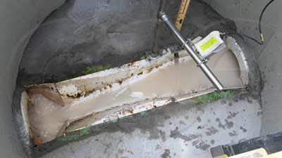 Large Trapezoidal flume monitoring industrial effluent in a fiberglass Packaged Metering Manhole