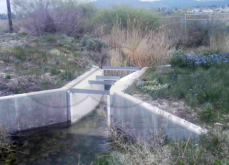 Parshall flume measuring outflow from a pond