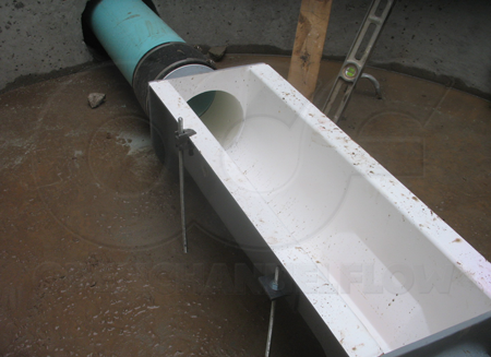 Leveling the Palmer-Bowlus flume during installation.  Threaded rod is run through the anchor clips in three locations.  In the last location a clamp is used on the top of the flume.  The anchor clip at this location came off when the contractor accidentally dropped the flume 8-feet down into the manhole.  Other than the anchor clip, there was no harm to the flume!