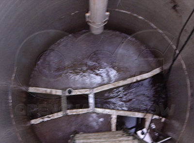 Parshall flume measuring industrial effluent in a fiberglass packaged metering manhole