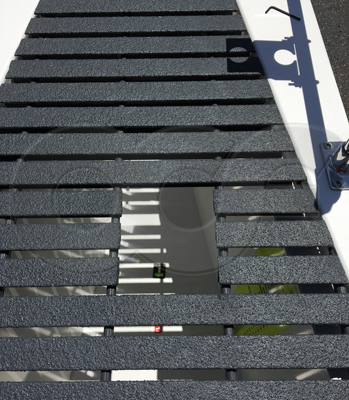cut-out in grating over a Parshall flume for an ultrasonic sensor