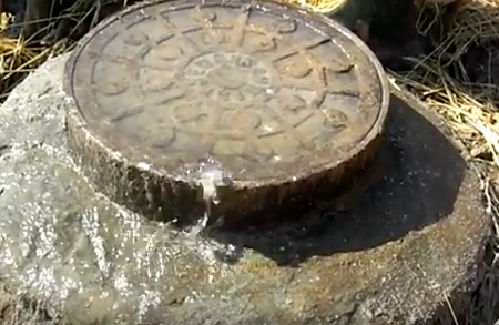 surcharge flow coming out of a manhole cover
