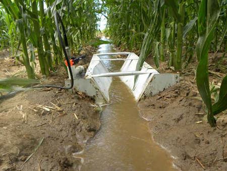 Trapezoidal Flume Measuring Irrigation Flows in a Furrow 