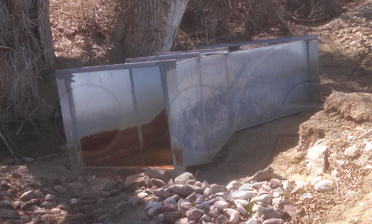 corrosion of the water line / discharge section of a galvanized steel Parshall flume measuring irrigation water rights