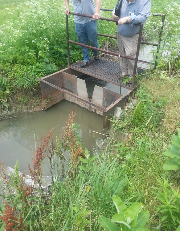 weir channel mounting a v-ntoch weir plate used to measure flow in stormwater runoff channel
