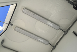 two fluorescent lights mounted in a single-piece fiberglass shelter-building
