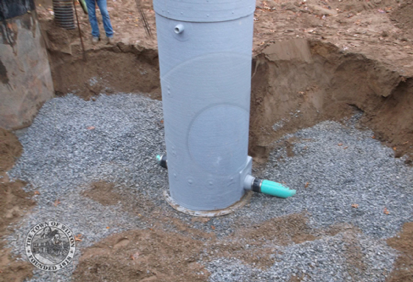 backfilling around a completed fiberglass manhole installation