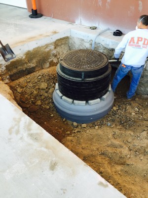 Manhole Grade Ring & Cover Stack over a PMM
