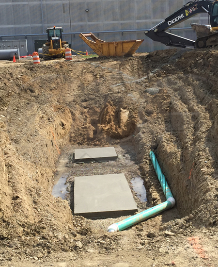 concrete pads for two fiberglass manholes