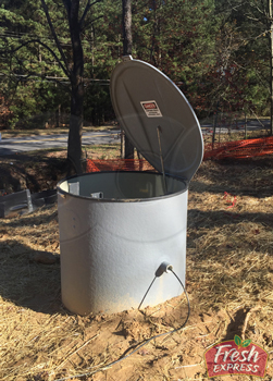 completed installation of a fiberglass domed top packaged metering manhole